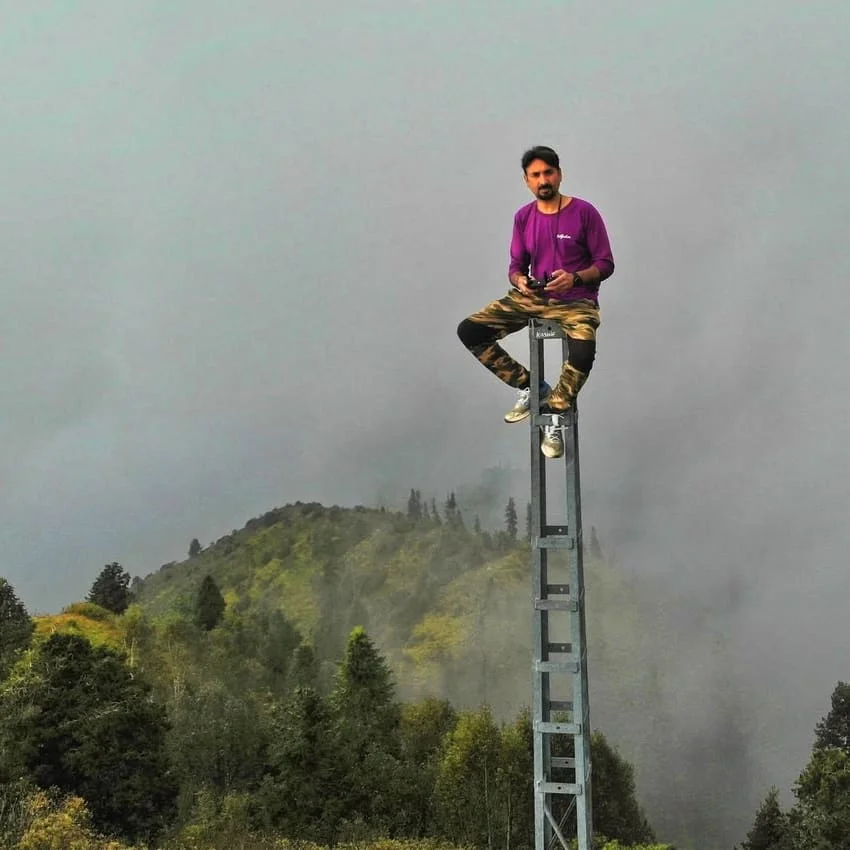 Standing at the summit cairn of Miranjani Peak overlooking the Galyat valleys